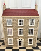 A large 20thC doll's house opening to reveal decorated rooms over 3 stories. 74cm x 96cm h to