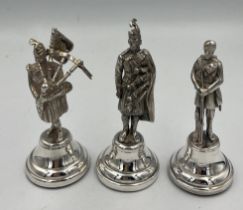 Hallmarked silver figures, two Scottish Highlanders and one Gurkha. Tallest 10cm h. London 1938,