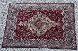 A good quality red ground wool carpet 315cm x 223cm.