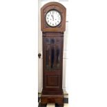 An oak and glassed cased chiming grandmother clock. 173 h x 42 w.