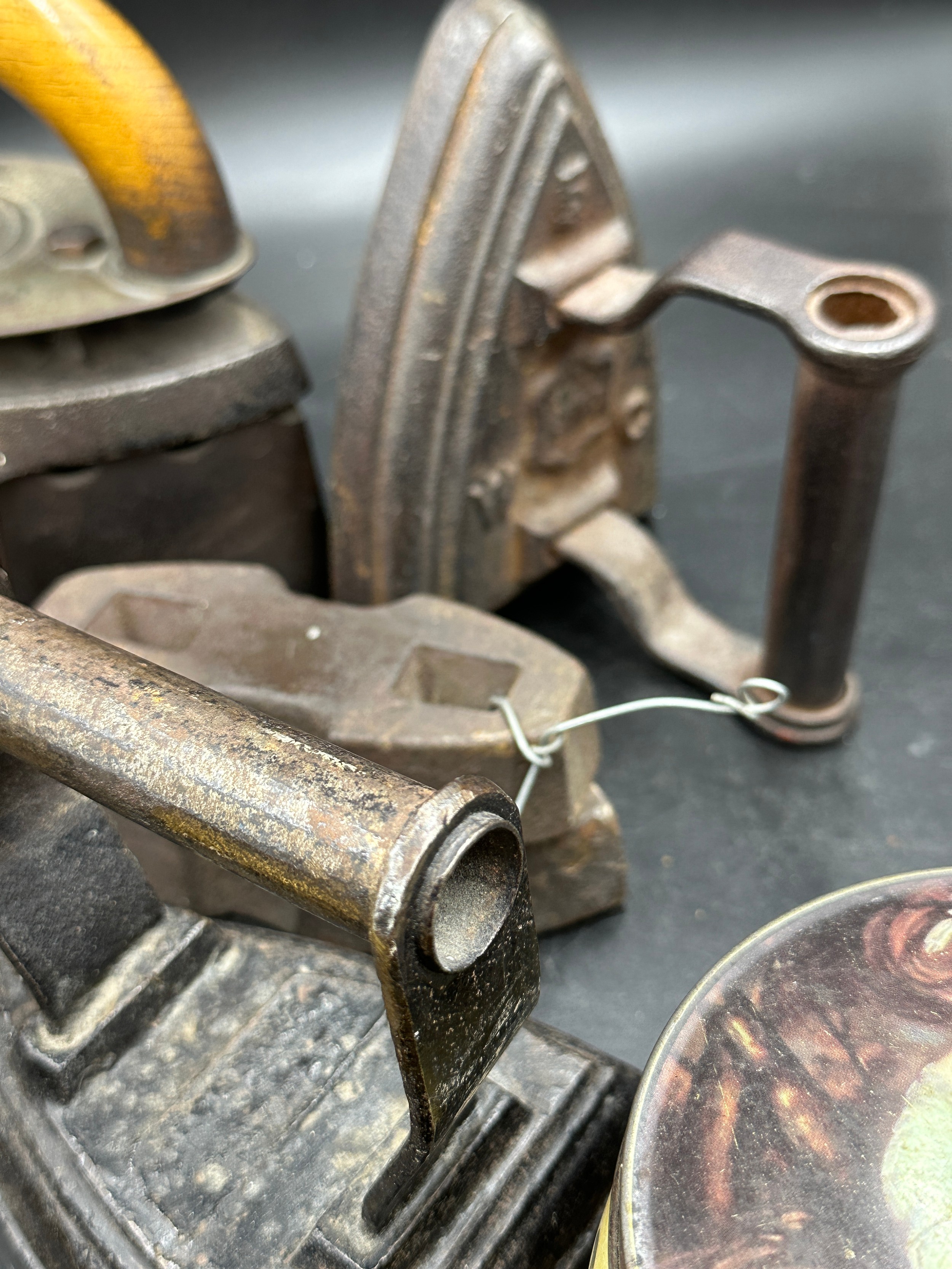 A collection of sad irons, CH Crane, Otto etc together with various tins to include Rowntree's - Image 8 of 10