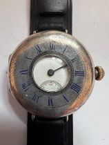 A silver cased half-hunter Waltham wristwatch, with blue enamelled Roman numerals to front case.