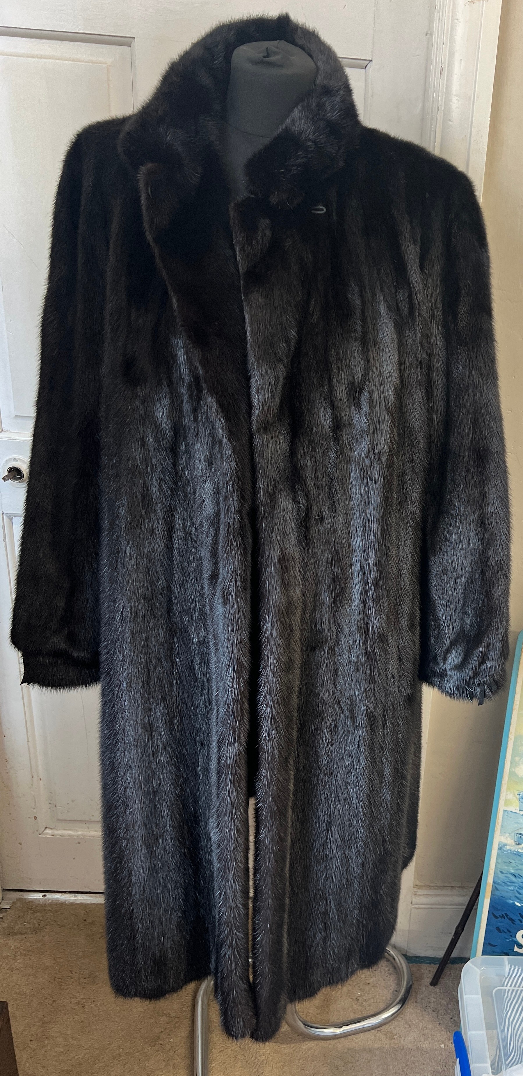 A long length black mink coat.