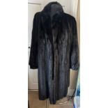 A long length black mink coat.