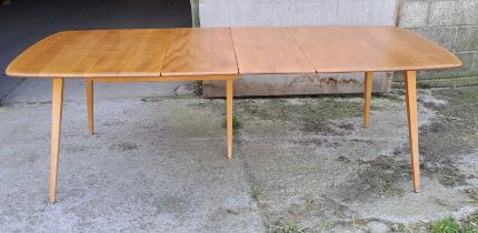 A mid 20thC Ercol extending dining table. Closed 82cm h x 152cm l x 91cm w, fully open 223cm l.