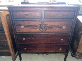 An American chest of two short over three long drawers with painted floral decoration to front.