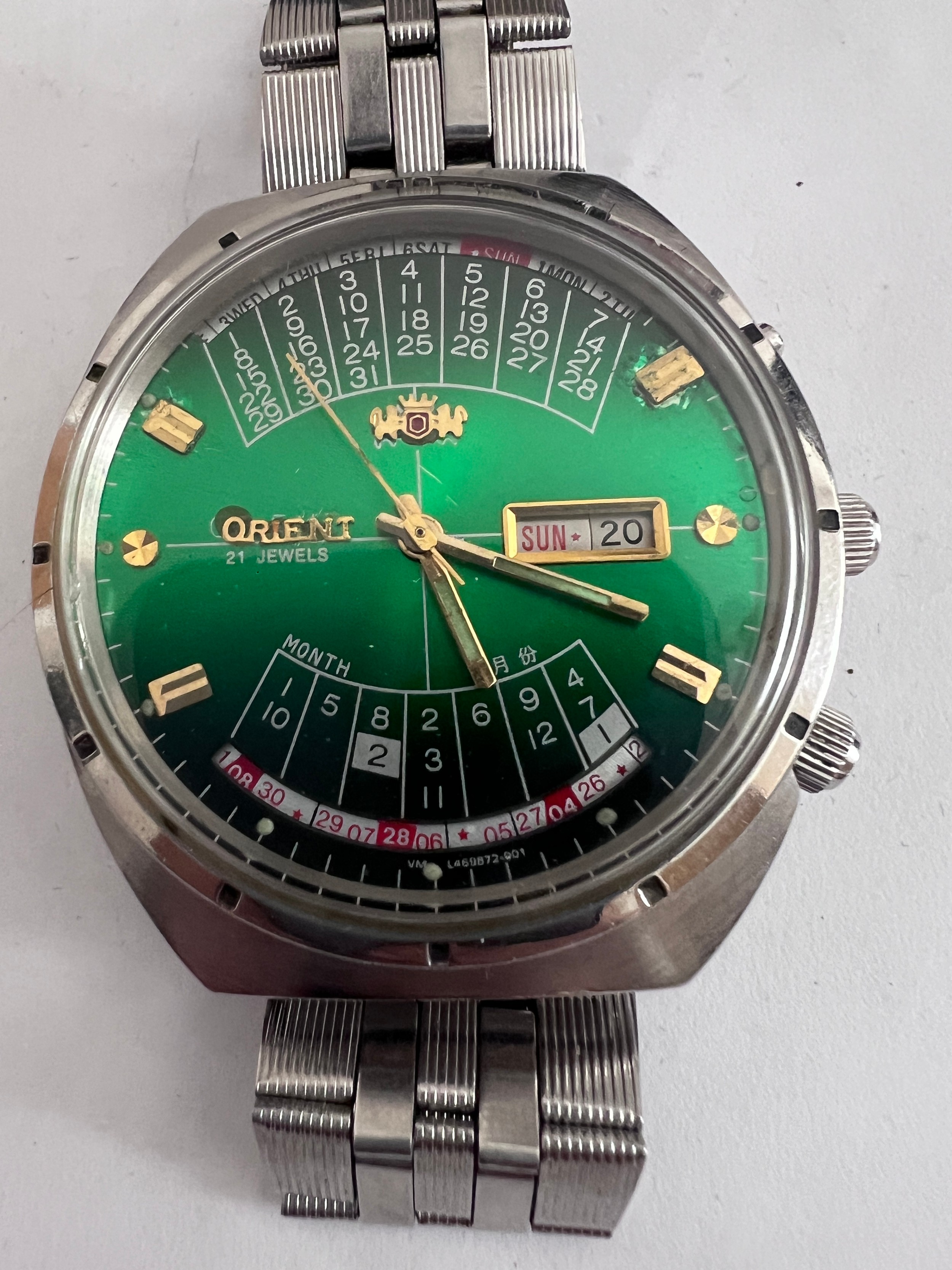 An Orient perpetual calendar automatic steel wristwatch with green gradient dial. Case numbered