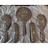 A 20thC cased hallmarked silver backed dressing table set comprising two hairbrushes, two clothes