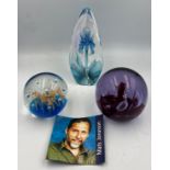Three glass paperweights to include Mats Jonasson Iris and Caithness Moonflower.