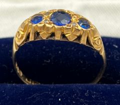 An 18 carat gold ring set with sapphires and diamonds. Size P/Q. Weight 2gm.