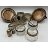 A quantity of hallmarked silver to include silver rimmed glass salts, salt spoons, small pepperette,