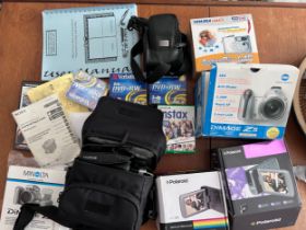 A collection of camera equipment to include Fujifilm Instant Camera Instax Wide 300, Polaroid