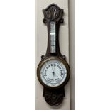 A 20thC oak carved hall mercury barometer with ceramic dial, 81cm h x 26cm at widest point.