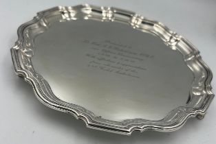 A hallmarked silver tray raised on three feet. Birmingham 1939. 21cm diameter. Weight 445gm.