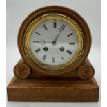 A 19thC oak cased mantel clock retailed by Reid & Sons Newcastle Upon Tyne. Movement stamped