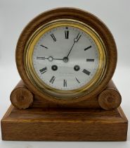 A 19thC oak cased mantel clock retailed by Reid & Sons Newcastle Upon Tyne. Movement stamped