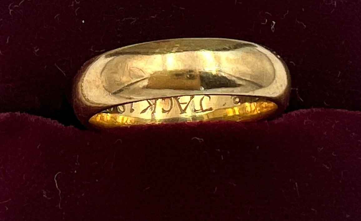 A 18 carat Welsh gold wedding band. Size K. Weight 4.7gm. With certificates.