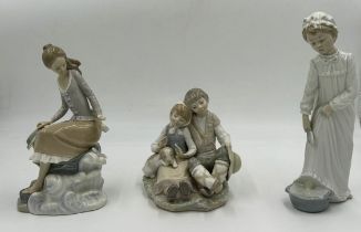 Three Lladro figurines to include 'At the seaside', 'Washing up girl', and 'Friendship.