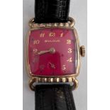 A 1952 gold plated manual dark red Bulova enamelled dial. With guarantee and Bulova case. Good