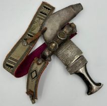 Arab silver mounted Jambia dagger with horn grip, ribbed curved blade and ornate sheath 31cm.