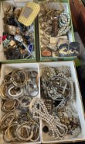 A cardboard jewellery box and contents to include a large quantity of vintage costume jewellery,