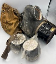 A vintage gas mask in canvas case. Marked S.G& Co Ltd. Jun. 1939.