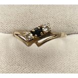 A 9 carat gold ring set with blue and clear stones. Size L, weight 1.1gm.