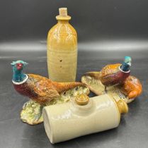 Two Beswick pheasant figurines, both 20cm h together with an Earthenware flask W.Wrangham Ltd Malton