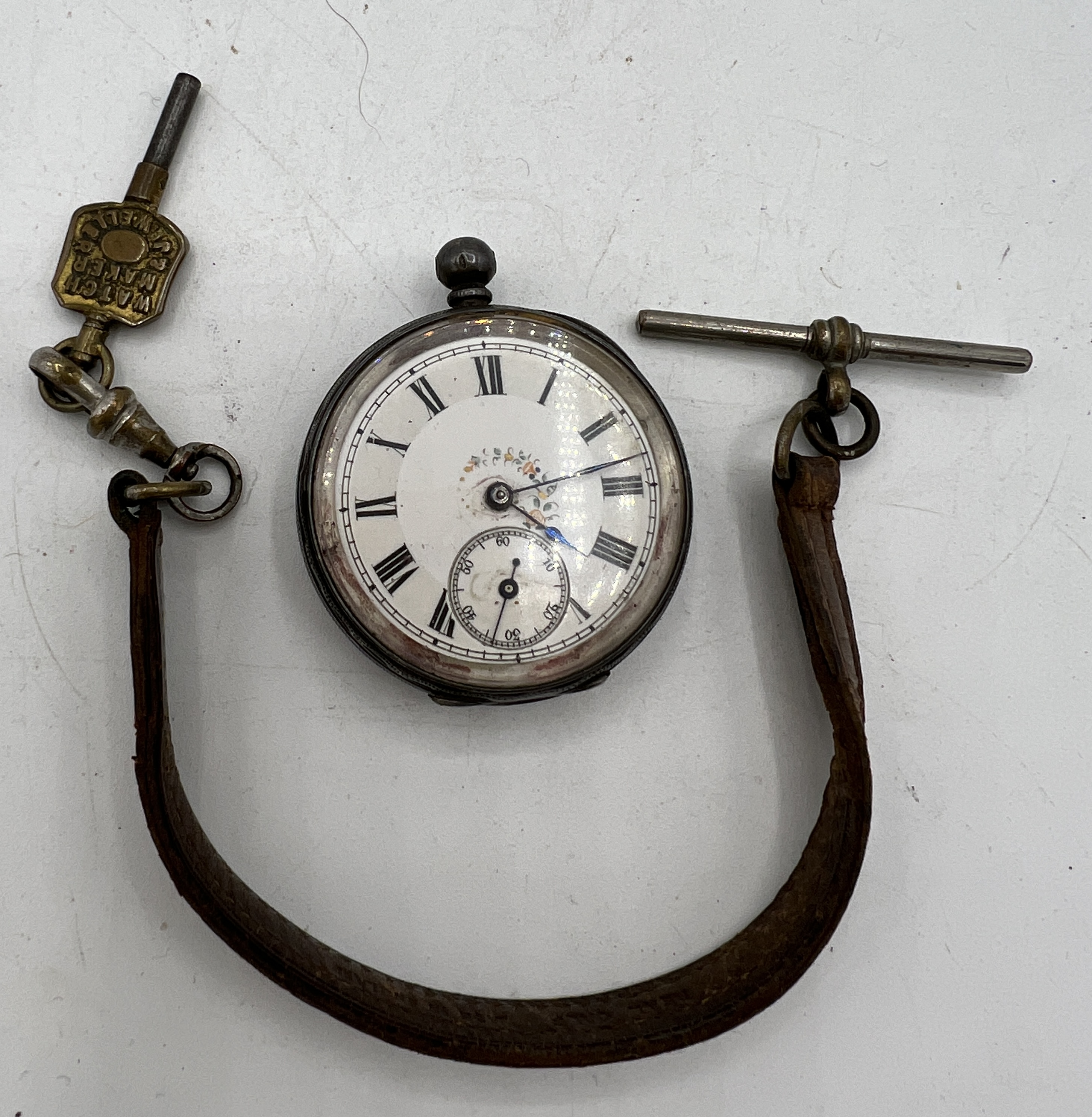 A Continental silver ladies pocket watch with leather strap and key.