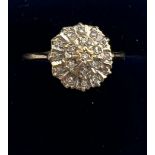 A 9 carat gold ring set with a cluster of clear stones. Size P. weight 1.9gm.