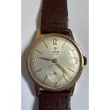 A 9ct gold gentleman's Tudor wristwatch. With original case, box and guarantee. Rolex crown.