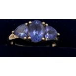 A 9 carat gold ring set with three blue stones. Size Q. Weight 3.1gm.