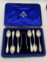 A cased set of six silver teaspoons and a pair of sugar tongs. London 1900, maker Wakely & Wheeler.