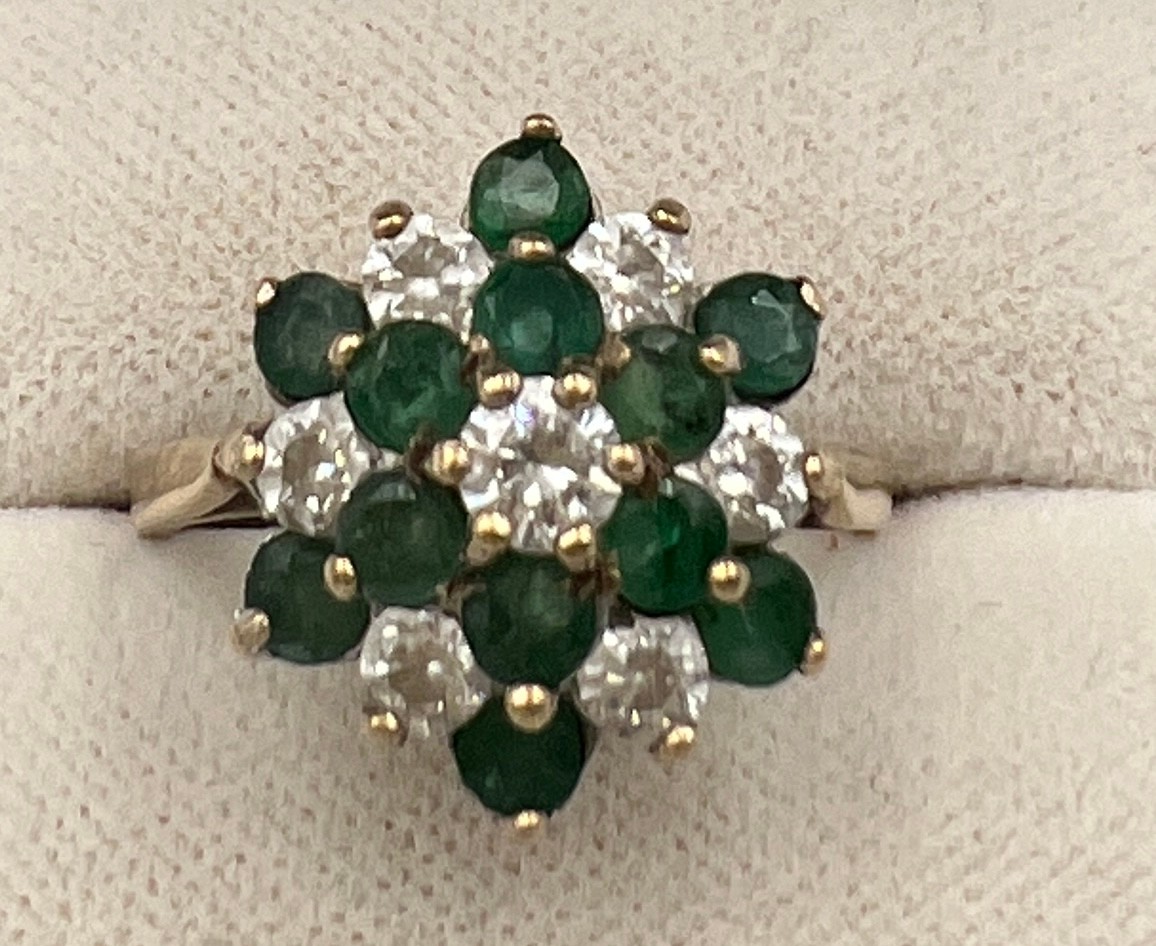 A 9 carat gold ring set with green and clear stones. Size N, weight 3.3gm.