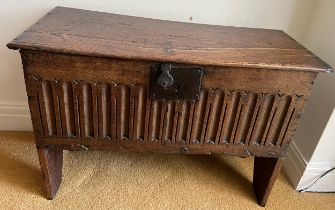 A 17thC oak six plank coffer with linen fold decoration to front. Iron lock. Replacement hinges.