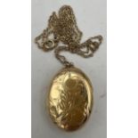 A nine carat gold oval etched locket on a fine nine carat gold chain. Total weight 7.5gm. Length