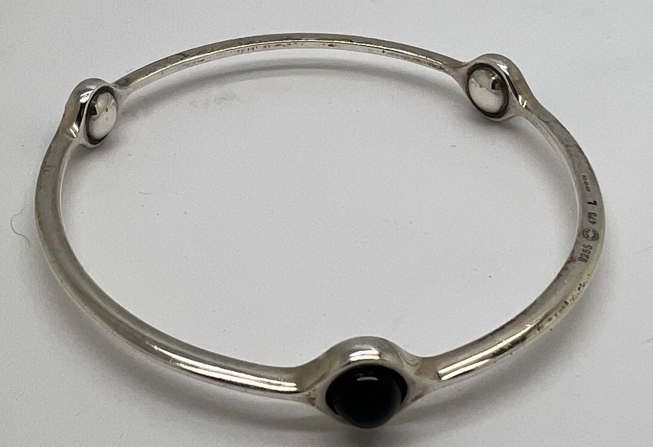 A Georg Jensen sterling silver sphere bangle 473 set with black onyx. Interior measurement 6.5gm.