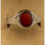 A 9 carat gold ring set with orange stone. Size O, weight 1.4gm.