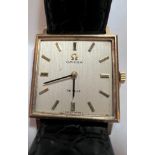 A 9ct gold gentleman's Omega De Ville wristwatch on black leather strap and cream coloured square