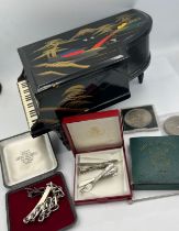 A miscellaneous lot to include grand piano black lacquer music box, crowns, silver identity