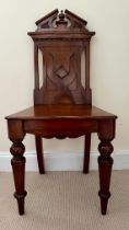 A mahogany hall chair with shield back, solid seat and turned legs. Ht 89 cm, to seat 44cm.