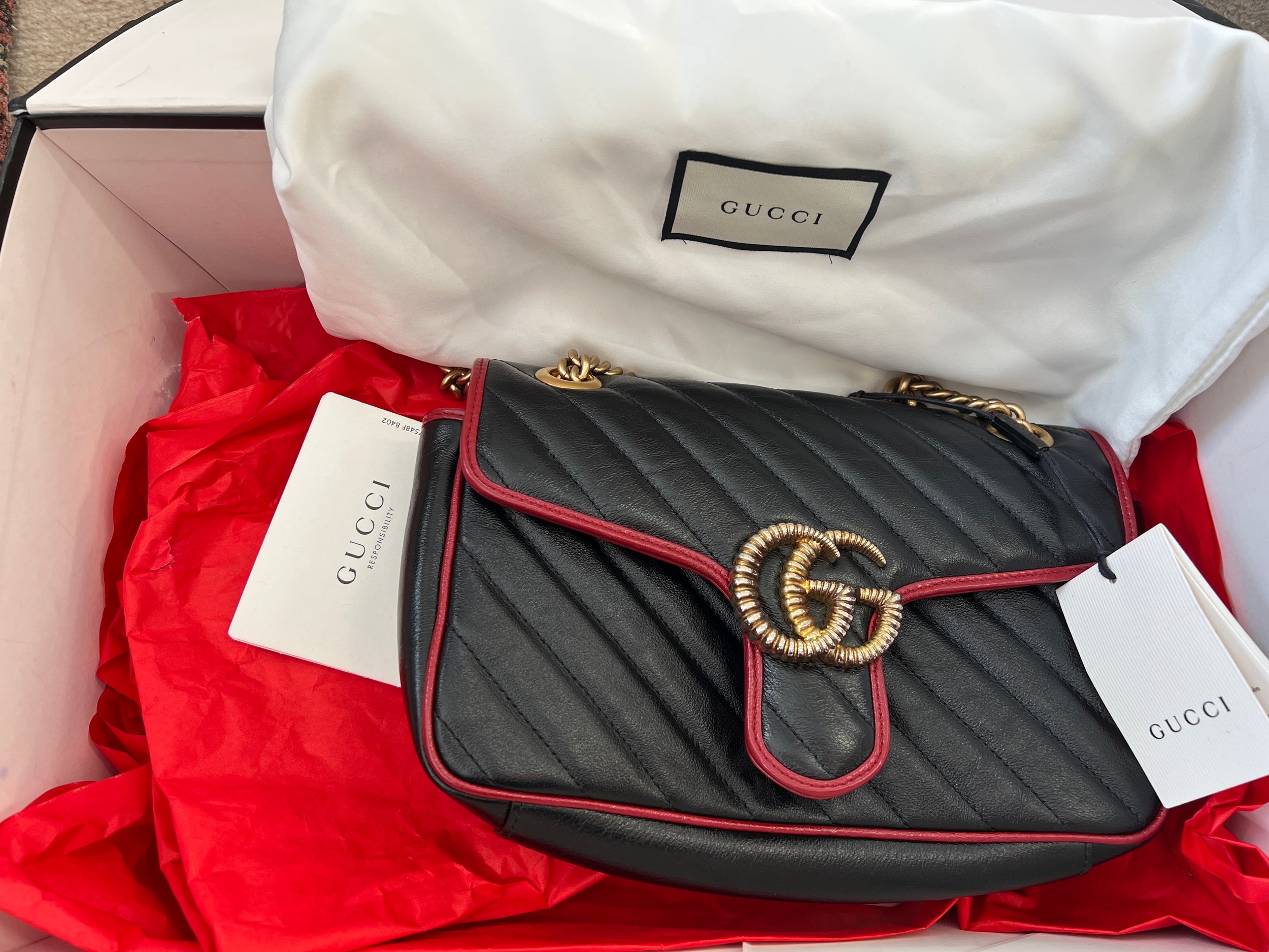A Gucci Marmont black with red trim and gold coloured chain hand bag, together with original box and - Image 2 of 9