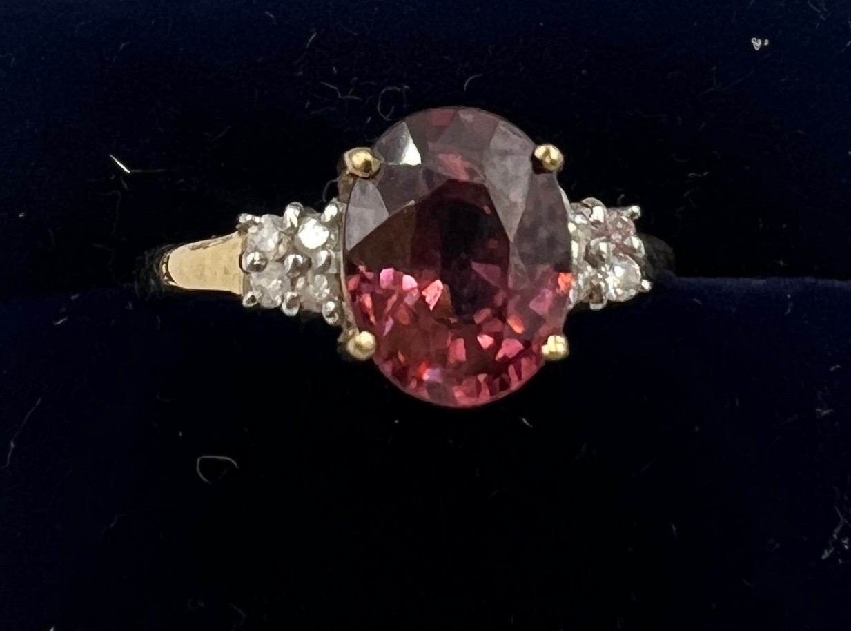 A 9 carat gold ring set with pink and clear stones. Size O. Weight 2.4gm.