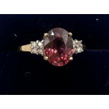 A 9 carat gold ring set with pink and clear stones. Size O. Weight 2.4gm.