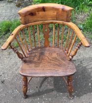 A Windsor style armchair with replacement top rail.