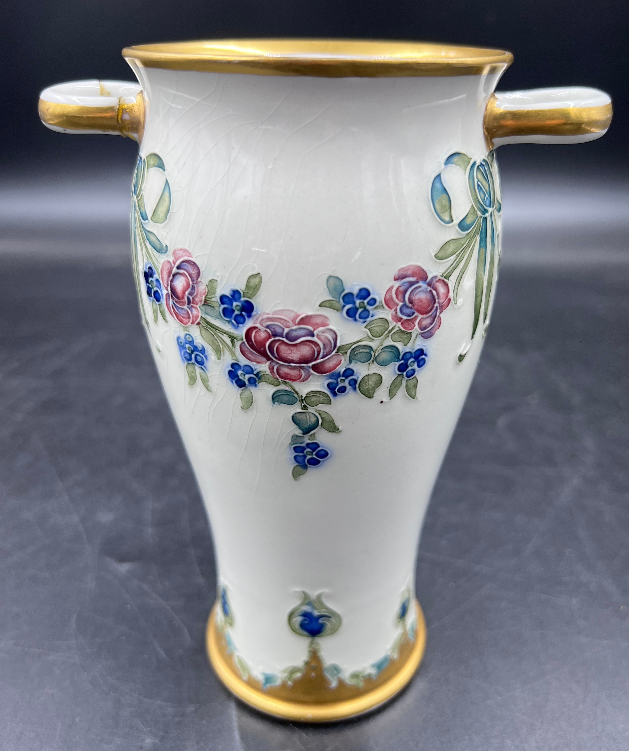 A William Moorcroft for Macintyre Burslem vase with floral garlands and rosettes. 19cms. Stamped - Image 2 of 5