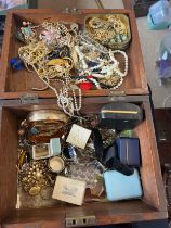 A quantity of vintage costume jewellery contained within an oak box.