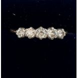 An 18 carat gold and platinum ring set with 5 diamonds. Weight 2.5gm. Size N.
