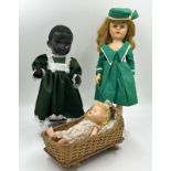 Collection of three dolls to include a Pedigree Composite Black Girl Doll (42cm) on stand in green