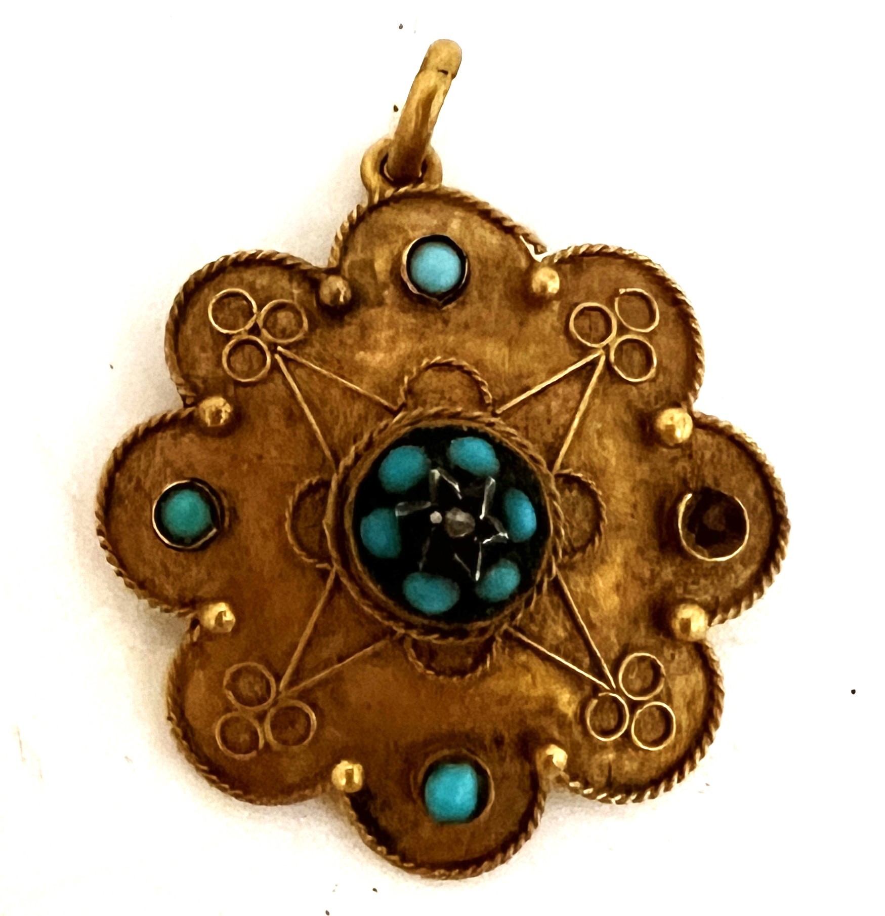 A 19thC 15 carat gold pendant set with turquoise and diamond chip. 2.5cm d. Weight 2.4gm.